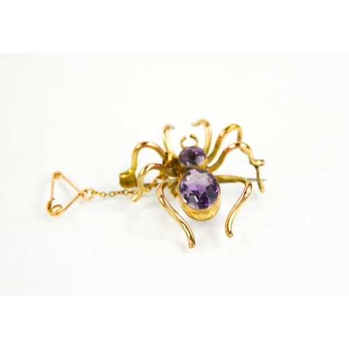 171 - A 9ct gold spider brooch set with amethyst, 4.5cms x 3cms, 5.3g.