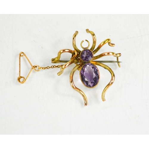 171 - A 9ct gold spider brooch set with amethyst, 4.5cms x 3cms, 5.3g.