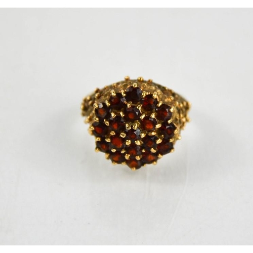 197 - A 9ct gold and garnet cluster ring, size N, 7.4g.