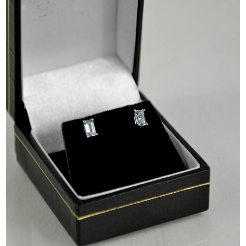 217 - A pair of 18ct white gold and aquamarine earrings, emerald cut.