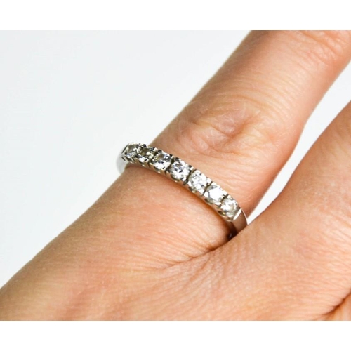 264 - An 18ct white gold and diamond ring, the seven diamonds totalling 0.4ct, size K½.