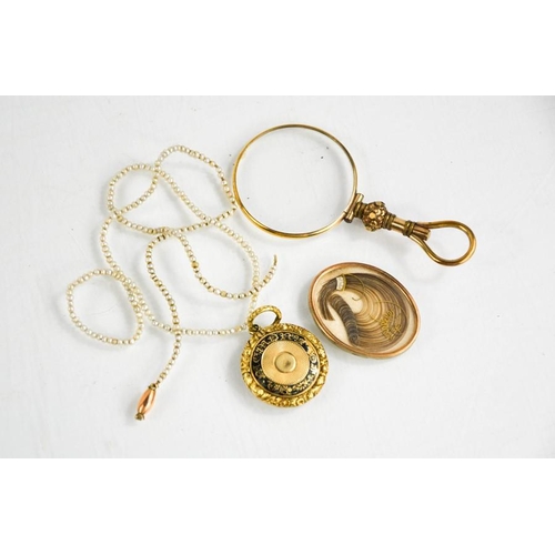 272 - A Victorian gilt metal mourning pendant containing a locket of hair, a gilt metal eye glass, a seed ... 