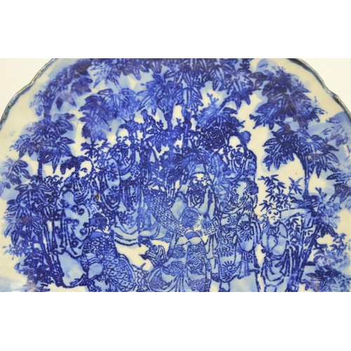 274 - A 19th century Chinese blue and white charger with scalloped edge depicting figural scenes together ... 