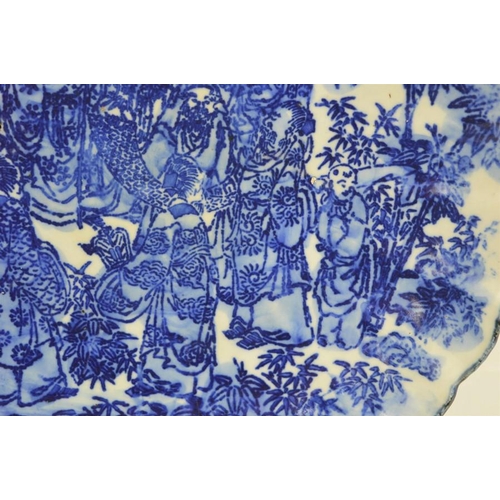 274 - A 19th century Chinese blue and white charger with scalloped edge depicting figural scenes together ... 