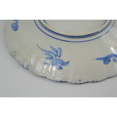 274 - A 19th century Chinese blue and white charger with scalloped edge depicting figural scenes together ... 