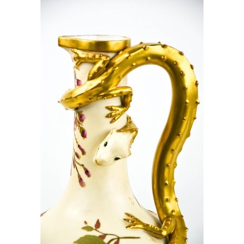 304 - A Royal Worcester blush ivory jug modelled with a gilded lizard with blue glass eyes, the body paint... 