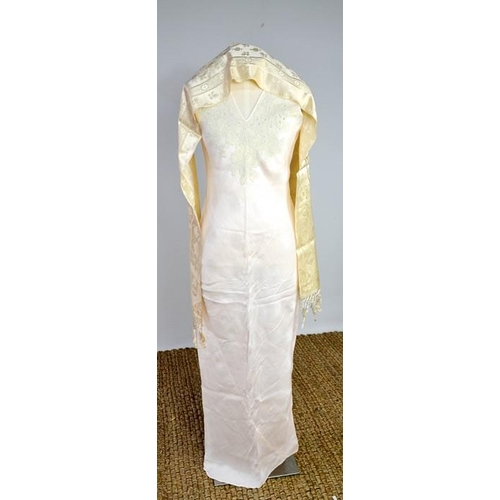 476 - An early 20th century cream silk scarf, embroidered with decoration, and a fine silk full length nig... 