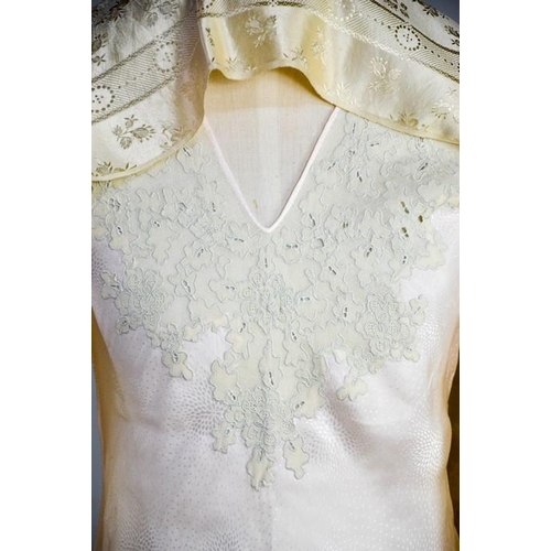 476 - An early 20th century cream silk scarf, embroidered with decoration, and a fine silk full length nig... 
