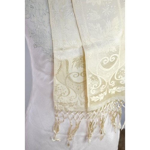 476 - An early 20th century cream silk scarf, embroidered with decoration, and a fine silk full length nig... 