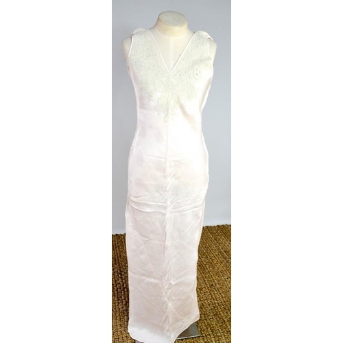 476 - An early 20th century cream silk scarf, embroidered with decoration, and a fine silk full length nig... 