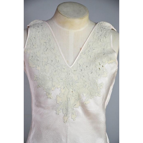 476 - An early 20th century cream silk scarf, embroidered with decoration, and a fine silk full length nig... 