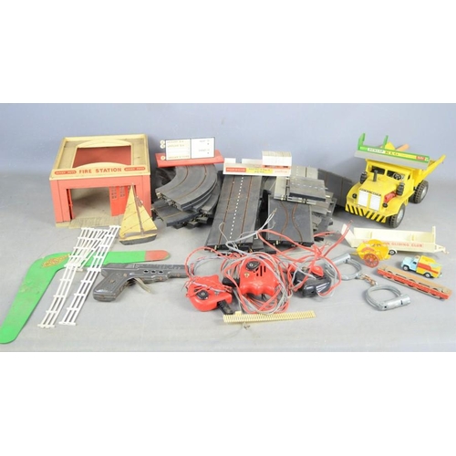 481 - A vintage Triang mimic motorways part set to include cars, track and controller, a toy gun and a Dai... 