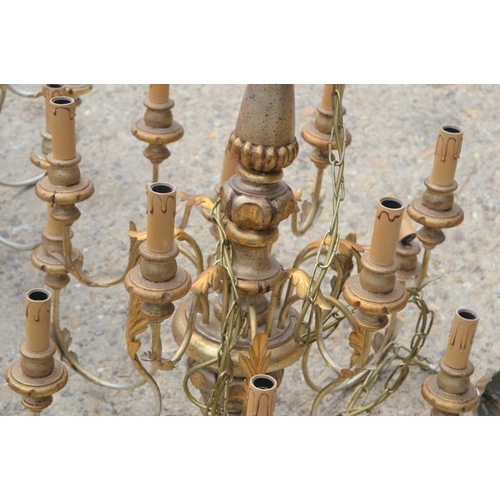 488 - A pair of 20th century wood and metal twelve branch chandeliers with gold decoration