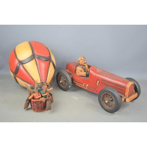 510 - A wooden British race car with steel and rubber wheels together with a composite hot air balloon