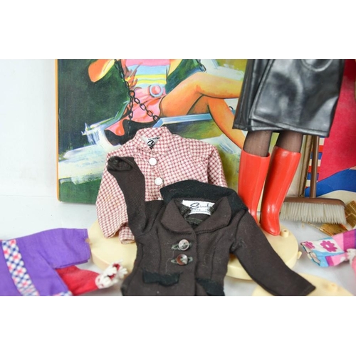 537 - Two vintage Sindy dolls, together with vintage clothing including Sindy examples and two Sindy books... 