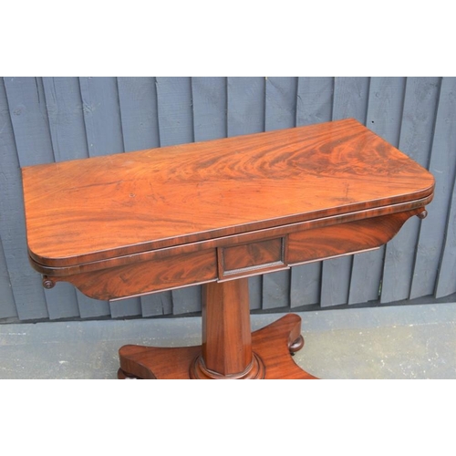 572 - A mahogany card table with swivel top, green baize lining and x-form base, 75cm high by 92cm wide by... 