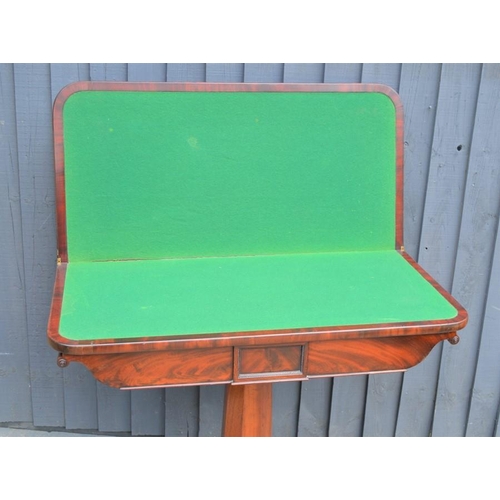 572 - A mahogany card table with swivel top, green baize lining and x-form base, 75cm high by 92cm wide by... 