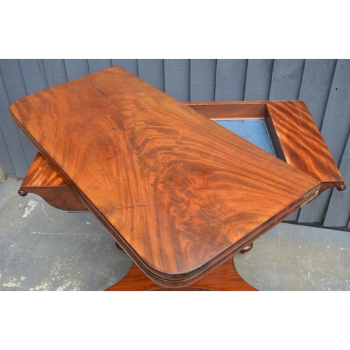 572 - A mahogany card table with swivel top, green baize lining and x-form base, 75cm high by 92cm wide by... 