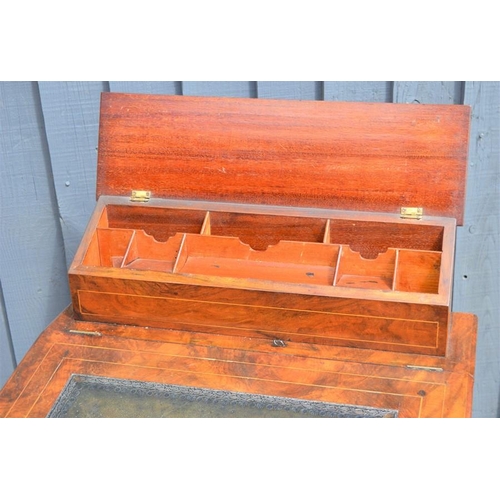574 - A Victorian mahogany davenport with correspondence compartment over sloped front and two shaped tier... 