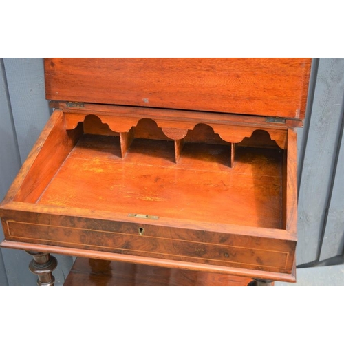 574 - A Victorian mahogany davenport with correspondence compartment over sloped front and two shaped tier... 