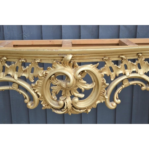 576 - A French style giltwood and marble top console table with pierced central cartouche and scrolling fo... 