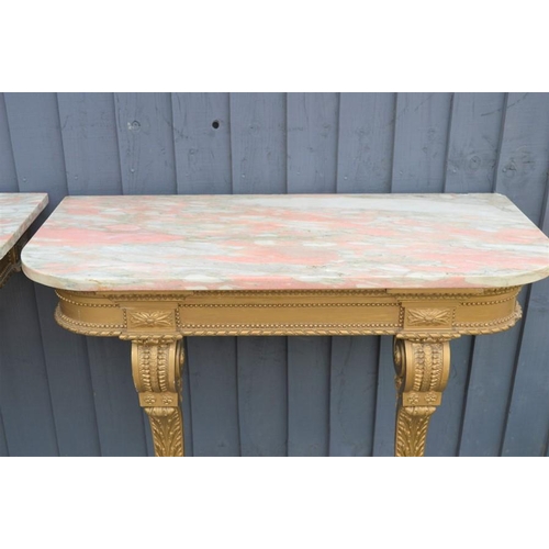 577 - A pair of Louis XVI style giltwood and marble top console tables with twin turned, carved and taperi... 