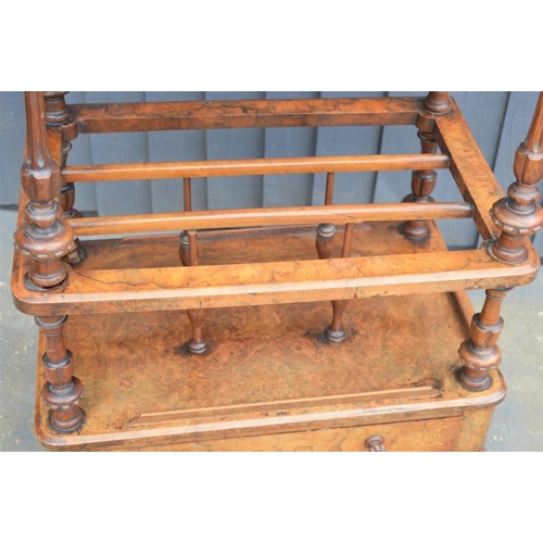 587 - A Victorian walnut veneer Canterbury whatnot with fretwork gallery, raised on turned supports, below... 