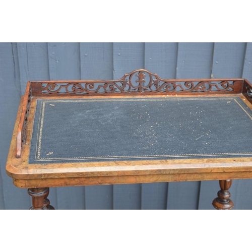 587 - A Victorian walnut veneer Canterbury whatnot with fretwork gallery, raised on turned supports, below... 