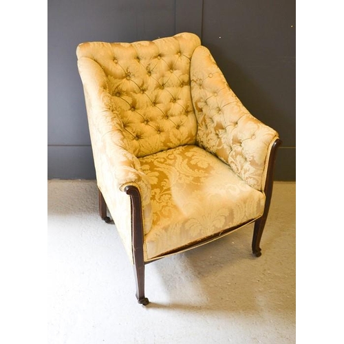 617 - A 19th century button back armchair, upholstered in cream, with a mahogany frame.