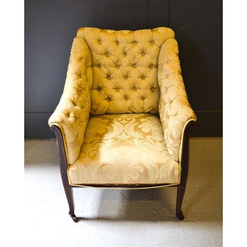 617 - A 19th century button back armchair, upholstered in cream, with a mahogany frame.