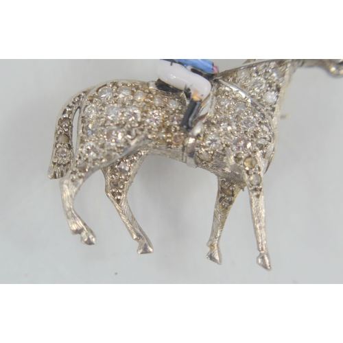 166 - A fine platinum, diamond and enamel brooch in the form of horse and jockey, the horse set with diamo... 