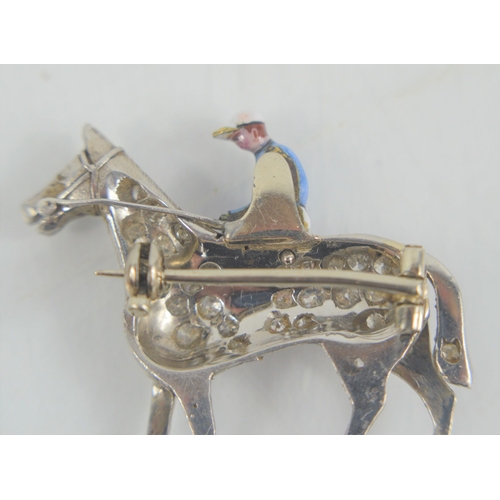 166 - A fine platinum, diamond and enamel brooch in the form of horse and jockey, the horse set with diamo... 