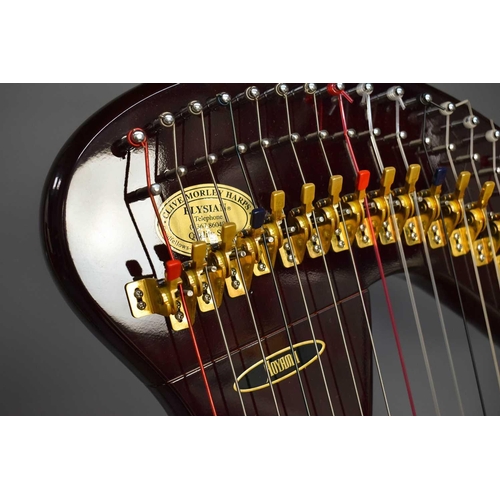 A modern Aoyama harp, raised on three turned feet, 145cm high. A modern Aoyama harp, raised on three turned feet, 145cm high.