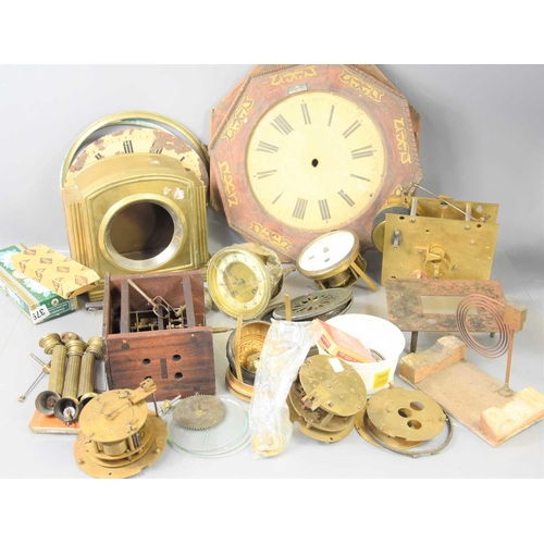 111 - A group of clock parts to include a brass mantle clock case, a fusse movement, clock dials, various ... 