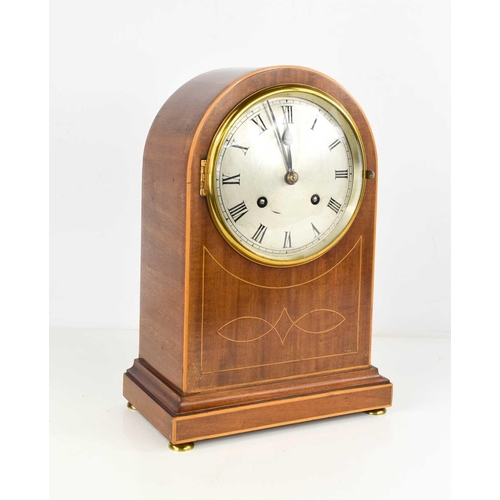 12 - An Edwardian mahogany domed mantle clock, inlaid with boxwood stringing, the convex glass door enclo... 