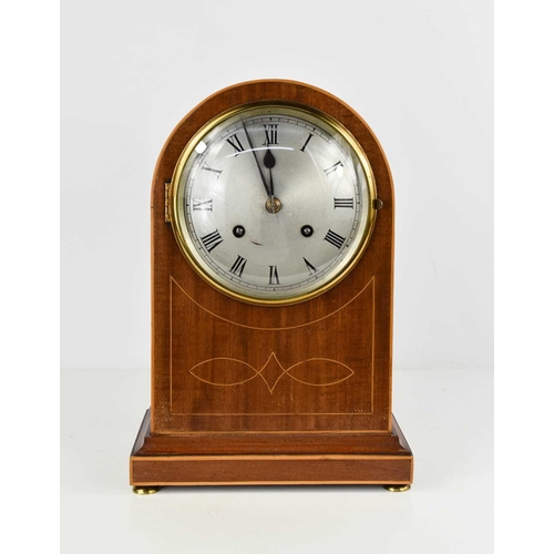 12 - An Edwardian mahogany domed mantle clock, inlaid with boxwood stringing, the convex glass door enclo... 