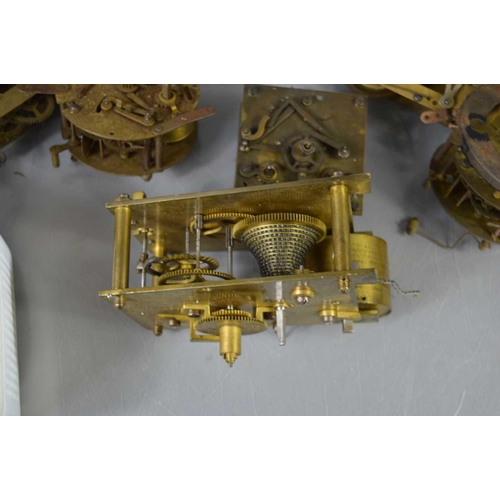 124 - A group of clock mechanisms to include a W.F Evans and Sons fusee movement and other parts.