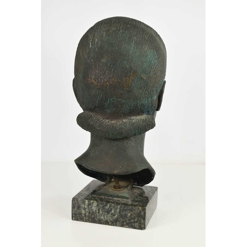 138 - A contemporary bronze sculpture of a female head, raised on a marble plinth, of green and brown pati... 