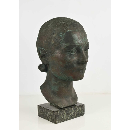 138 - A contemporary bronze sculpture of a female head, raised on a marble plinth, of green and brown pati... 