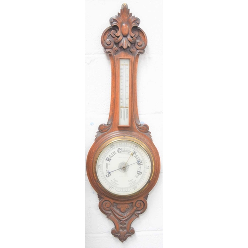 14 - A Victorian carved oak cased aneroid barometer, signed Beasley and Son, 92cms tall