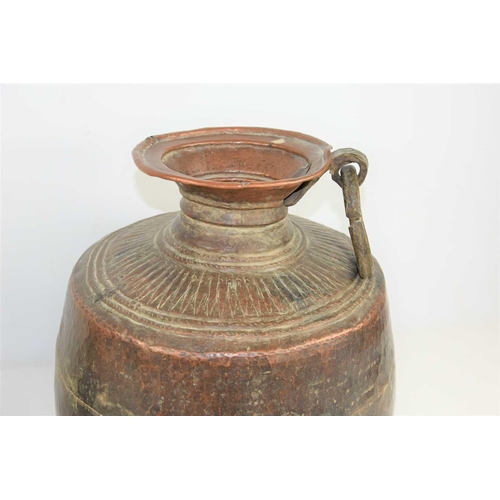 198 - A 19th century Indian Mughal hammered copper water storage pot, 31cm high together with a copper jug... 