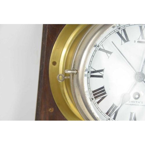 25 - A 20th century Smiths brass cased bulkhead clock with a single train eight-day movement, 19cms diame... 