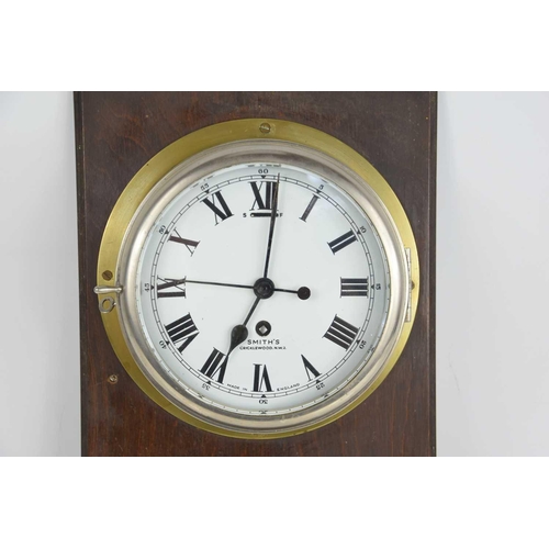 25 - A 20th century Smiths brass cased bulkhead clock with a single train eight-day movement, 19cms diame... 