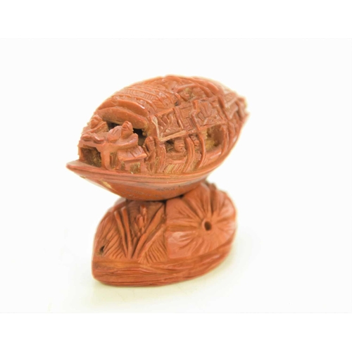 288 - A Chinese nut boat sculpture on stand, intricately carved with passengers looking out, the underside... 