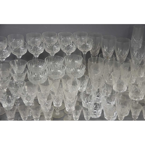 307 - A large group of mainly Stuart crystal drinking glasses of various sizes and styles.