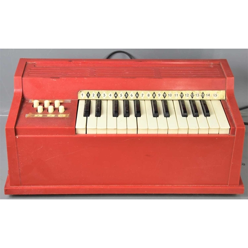 321 - A vintage electric childs organ possibly made by Magnus together with a push penny board.