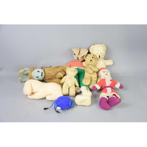 326 - A group of vintage teddy bears and soft toys to include some straw filled examples.