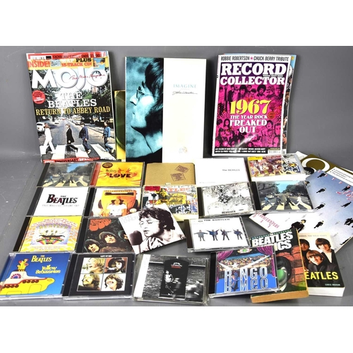 328 - A group of Beatles memorabilia to include magazines, books and various albums including Revolver, Ru... 