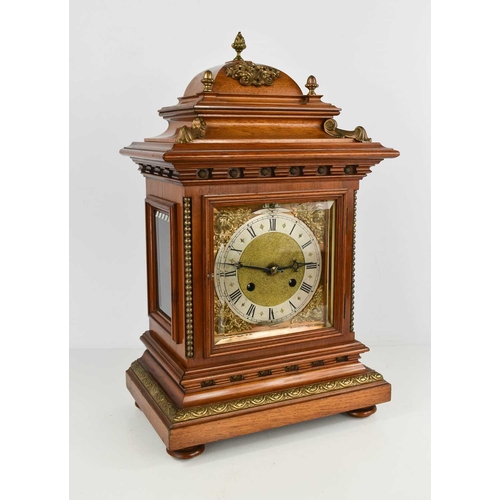 34 - A mahogany cased bracket clock, with domed top above a bevelled glass doors enclosing a silvered Rom... 