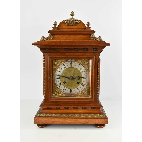 34 - A mahogany cased bracket clock, with domed top above a bevelled glass doors enclosing a silvered Rom... 